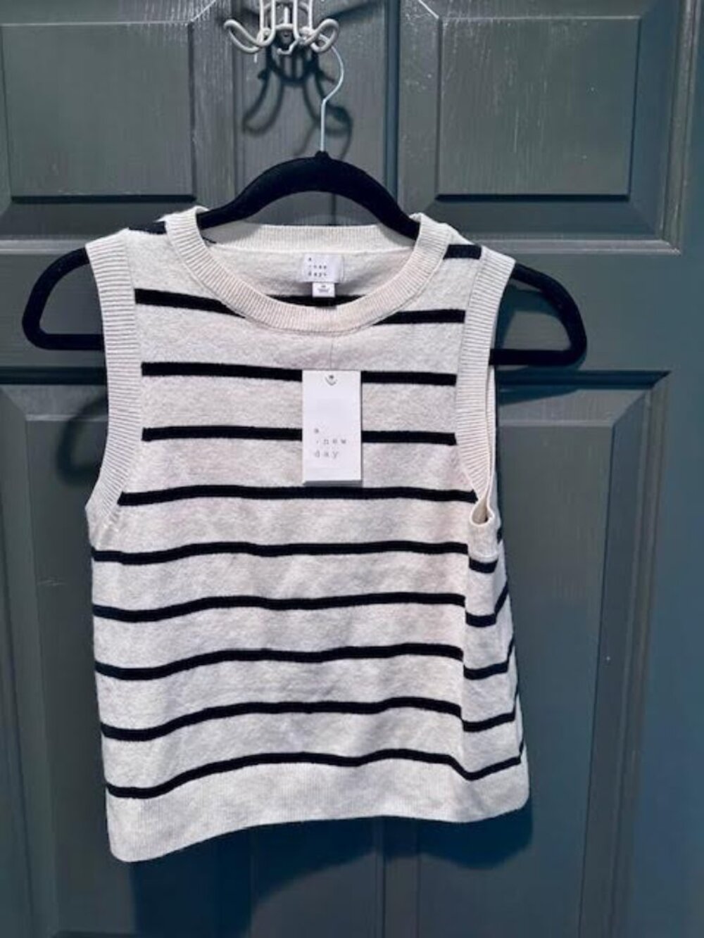 Sleeveless beige and black stripe sweater. Size medium.  NWT